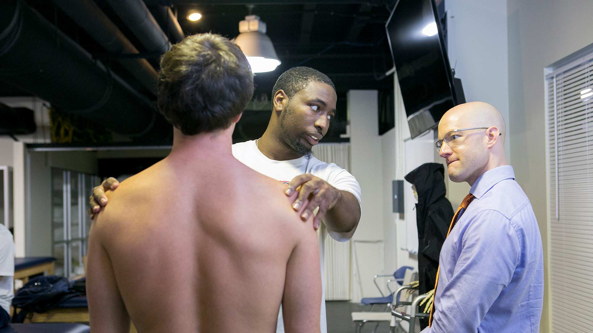 physical therapy student learning from professor