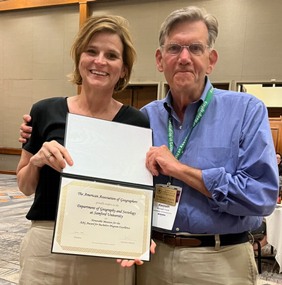 Professor and chair Jennifer Speights-Binet receiving the AAG Department Excellence Award at the AAG Conference in April 2024.