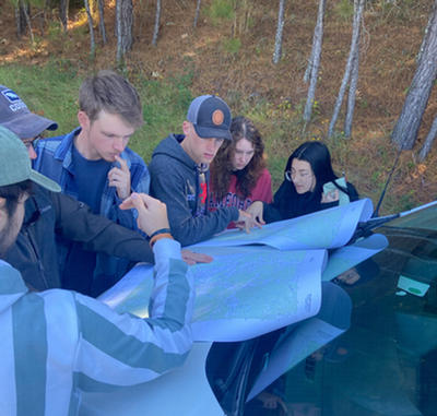 Geography students study topographic maps before heading out on a hike Landscapes of the American Southeast course.