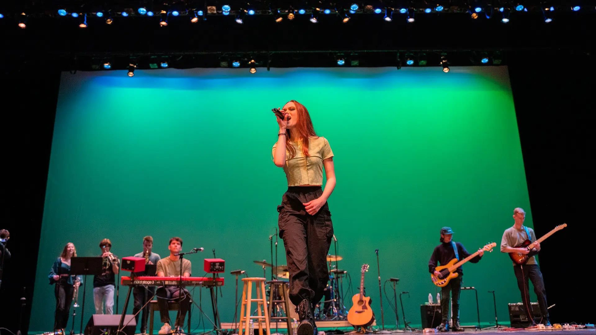 woman singing with backup band