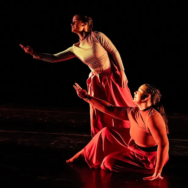 two female dancers dark stage