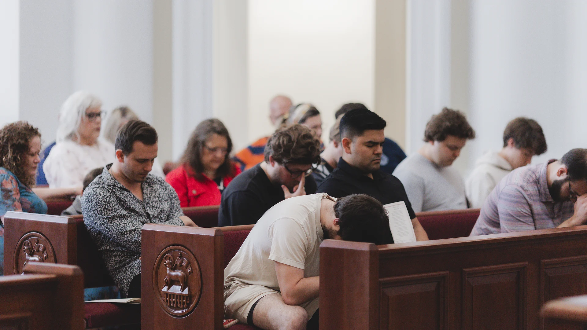 students praying in chapel SC04162024390