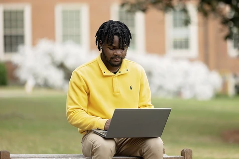 Two female students looking at a computer screen Student Registering