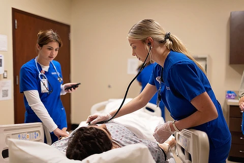 two female nurses working with patient